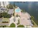 View of clubhouse, swimming pool, and parking at this desirable waterfront condo complex at 9495 Blind Pass Rd # 206, St Pete Beach, FL 33706