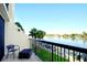 Relax on this condo balcony overlooking the water, lush lawn, and boat docks at 9495 Blind Pass Rd # 206, St Pete Beach, FL 33706