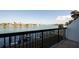 Condo view of boat dock from a balcony with boat lifts and grassy lawn at 9495 Blind Pass Rd # 206, St Pete Beach, FL 33706