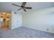 Neutral bedroom with ceiling fan, carpeted floor, closet and a partial view into the bathroom at 9495 Blind Pass Rd # 206, St Pete Beach, FL 33706