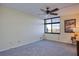 Inviting bedroom featuring a ceiling fan, large windows, and plush carpeting, creating a comfortable space at 9495 Blind Pass Rd # 206, St Pete Beach, FL 33706