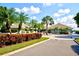 Stunning clubhouse with lush tropical landscaping, a welcoming entrance, and a circular driveway at 9495 Blind Pass Rd # 206, St Pete Beach, FL 33706