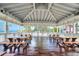 Gazebo interior featuring picnic tables with a glimpse of the beach and ocean at 9495 Blind Pass Rd # 206, St Pete Beach, FL 33706