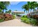 Picturesque gazebo nestled among lush landscaping with a paved walkway leading to it at 9495 Blind Pass Rd # 206, St Pete Beach, FL 33706