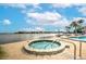 Inviting outdoor hot tub with lounge chairs and a beautiful view of the waterway at 9495 Blind Pass Rd # 206, St Pete Beach, FL 33706