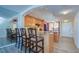 Kitchen featuring breakfast bar seating, under cabinet lighting, and hardwood floors at 9495 Blind Pass Rd # 206, St Pete Beach, FL 33706