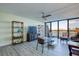 Bright living room featuring a ceiling fan, shelving, and view of the water at 9495 Blind Pass Rd # 206, St Pete Beach, FL 33706