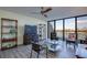 Bright living room featuring a ceiling fan, shelving, and view of the water at 9495 Blind Pass Rd # 206, St Pete Beach, FL 33706