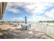 Waterfront deck featuring tables with umbrellas, providing a serene outdoor experience at 9495 Blind Pass Rd # 206, St Pete Beach, FL 33706