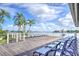 Sunny pool deck featuring lounge chairs, scenic views, and waterfront access at 9495 Blind Pass Rd # 206, St Pete Beach, FL 33706