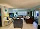 Bright living room with comfy seating and a large TV at 2753 Countryside Blvd # 105, Clearwater, FL 33761