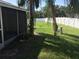 Backyard view showcasing a grassy area and privacy fence at 3198 Claremont Pl # D, Palm Harbor, FL 34683