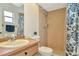 Tiled bathroom featuring a shower and single sink vanity at 13084 Drysdale St, Spring Hill, FL 34609