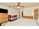 A comfortable bedroom with a crib, ceiling fan, and a large dresser at 13084 Drysdale St, Spring Hill, FL 34609