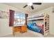 Youth bedroom with carpet flooring, desk, bunkbeds, and natural light from a large window at 13084 Drysdale St, Spring Hill, FL 34609