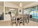 Dining room with gray table and chairs and sliding glass doors to the pool area at 13084 Drysdale St, Spring Hill, FL 34609