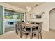 Dining room with gray table and chairs and sliding glass doors to the patio and pool at 13084 Drysdale St, Spring Hill, FL 34609