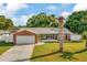 Charming single-story home with brick details, an attached garage, and well-kept lawn at 13084 Drysdale St, Spring Hill, FL 34609