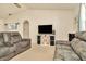 Cozy living room with plush sofas and a modern entertainment center with storage at 13084 Drysdale St, Spring Hill, FL 34609