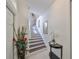 Bright entryway with elegant staircase and decorative accents at 1361 Emerald Dunes, Sun City Center, FL 33573