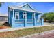 Charming blue house with a front porch and well-maintained lawn at 2601 N 19Th St, Tampa, FL 33605