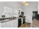 Modern kitchen with white cabinets, granite counters, and wood floors at 2601 N 19Th St, Tampa, FL 33605