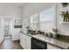 Modern kitchen with white cabinets, granite counters, and wood floors at 2601 N 19Th St, Tampa, FL 33605