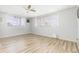 Bright bedroom with light wood floors and two large windows at 7903 Hyde Park Ave, North Port, FL 34287