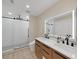 Modern bathroom with double vanity, walk-in shower, and patterned tile floor at 9841 San Sebastian Way, Port Richey, FL 34668