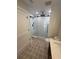 Elegant bathroom with walk-in shower, pebble tile, and modern fixtures at 9841 San Sebastian Way, Port Richey, FL 34668