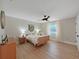 Serene bedroom featuring a rattan bed frame and mid-century modern dresser at 9841 San Sebastian Way, Port Richey, FL 34668