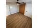 Spacious bedroom with light walls, wood-look flooring, and a built-in closet at 9841 San Sebastian Way, Port Richey, FL 34668