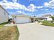 Front view of a single-story house with a white garage door and a landscaped yard at 9841 San Sebastian Way, Port Richey, FL 34668