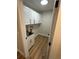 Laundry room with white cabinets, a utility sink, and wood-look flooring at 9841 San Sebastian Way, Port Richey, FL 34668