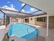 Inviting screened pool area with a spacious deck at 9841 San Sebastian Way, Port Richey, FL 34668