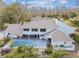 Home's exterior boasts a large backyard with a pool at 17307 Linda Vista Cir, Lutz, FL 33548