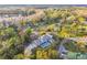 House with pool and driveway, nestled in a wooded area near a lake at 17307 Linda Vista Cir, Lutz, FL 33548