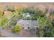 Aerial view of a house and surrounding landscape, including a lake and trees at 17307 Linda Vista Cir, Lutz, FL 33548