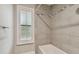 Clean bathroom with a bathtub and neutral-toned tile at 17307 Linda Vista Cir, Lutz, FL 33548