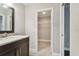 Modern bathroom with marble vanity and walk-in closet at 17307 Linda Vista Cir, Lutz, FL 33548