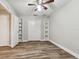 Cozy bedroom with built in shelving and wood-look floors at 17307 Linda Vista Cir, Lutz, FL 33548