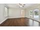 Spacious bedroom with dark hardwood floors and access to a patio at 17307 Linda Vista Cir, Lutz, FL 33548