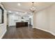 Open dining room with view into kitchen and hardwood floors at 17307 Linda Vista Cir, Lutz, FL 33548
