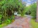 Long driveway leading to a charming house in a wooded area at 17307 Linda Vista Cir, Lutz, FL 33548