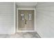 Double front doors with glass accents and decorative carvings at 17307 Linda Vista Cir, Lutz, FL 33548