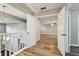 Upstairs hallway with wood-look flooring and access to bedrooms at 17307 Linda Vista Cir, Lutz, FL 33548