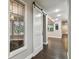 Elegant hallway with barn door and stained glass window at 17307 Linda Vista Cir, Lutz, FL 33548