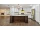 Renovated kitchen with island, stainless steel appliances, and white shaker cabinets at 17307 Linda Vista Cir, Lutz, FL 33548