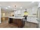 Modern kitchen with white cabinets, large island, and stainless steel appliances at 17307 Linda Vista Cir, Lutz, FL 33548