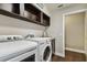 Laundry room with washer, dryer, and shelving at 17307 Linda Vista Cir, Lutz, FL 33548